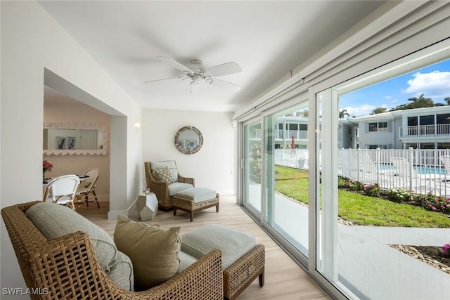 sunroom / solarium featuring a ceiling fan