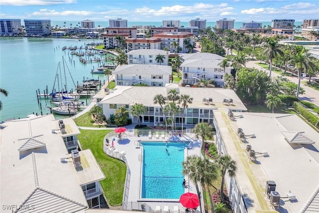 drone / aerial view featuring a city view and a water view