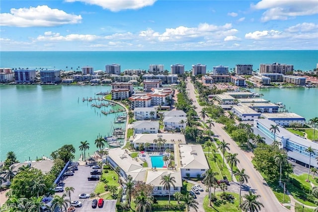 drone / aerial view featuring a city view and a water view