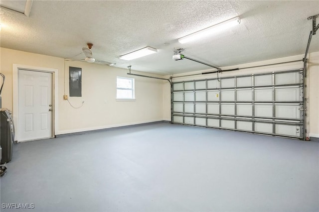 garage with electric panel, a garage door opener, and baseboards