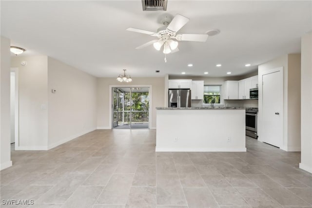 kitchen with visible vents, ceiling fan with notable chandelier, stainless steel appliances, and a healthy amount of sunlight