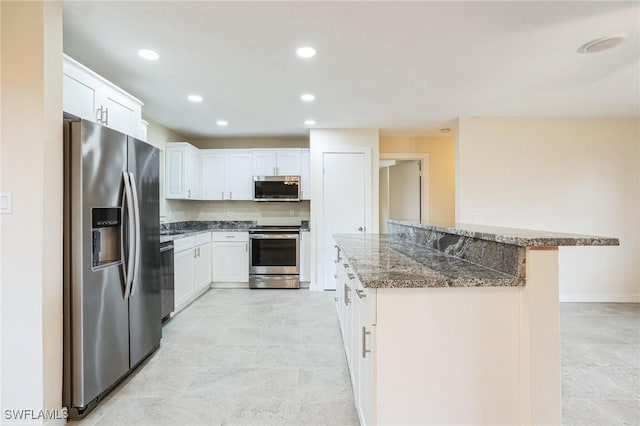 kitchen with white cabinets, recessed lighting, appliances with stainless steel finishes, and a center island