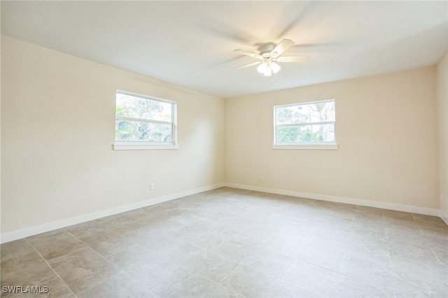 unfurnished room featuring baseboards and ceiling fan