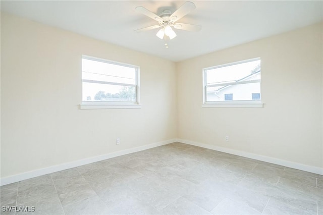 empty room with baseboards and a ceiling fan