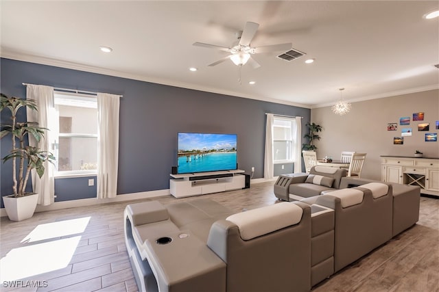 living area with crown molding, plenty of natural light, visible vents, and light wood-type flooring