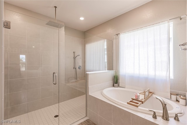 bathroom with a shower stall and a garden tub