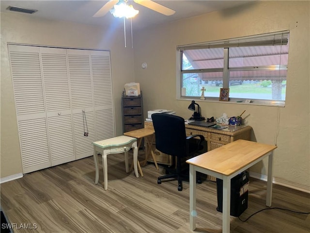 office space with baseboards, visible vents, wood finished floors, and ceiling fan