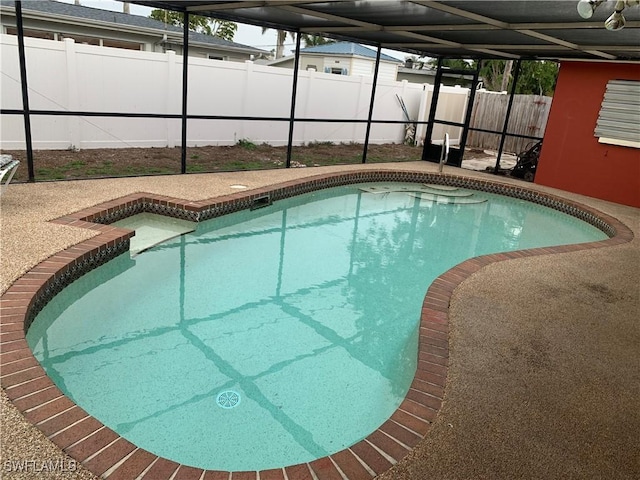 view of pool with a lanai, a patio area, a fenced in pool, and a fenced backyard