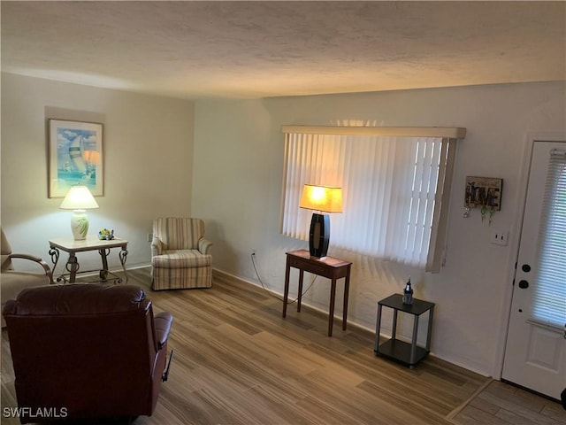 interior space with wood finished floors and a textured ceiling