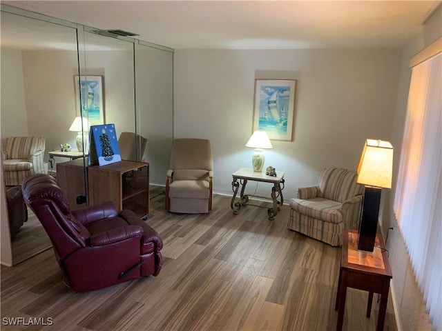 sitting room with visible vents and wood finished floors