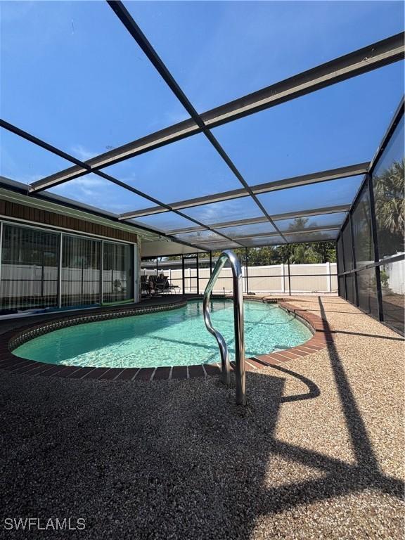 pool with a patio, a lanai, and a fenced backyard