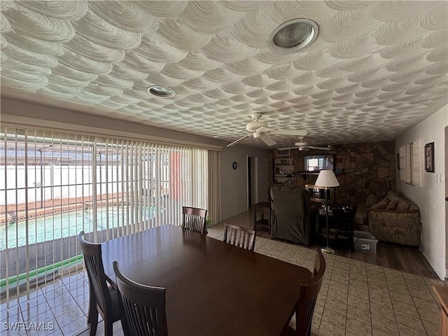 dining space with wood finished floors and a ceiling fan