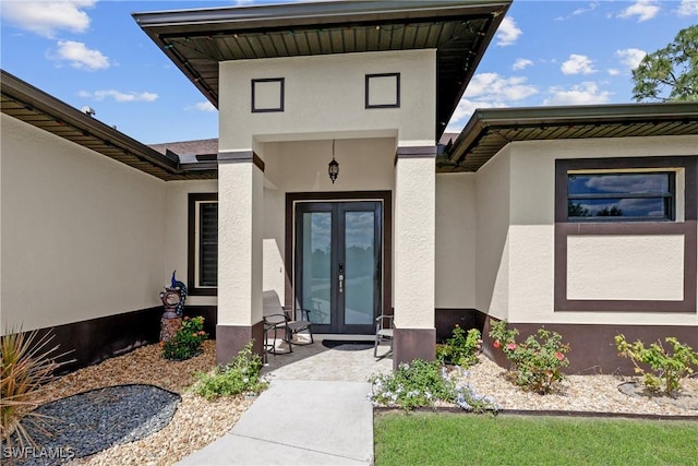 doorway to property with stucco siding and french doors