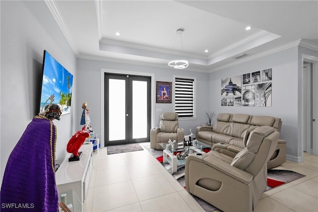 living area featuring a tray ceiling, french doors, crown molding, and tile patterned flooring