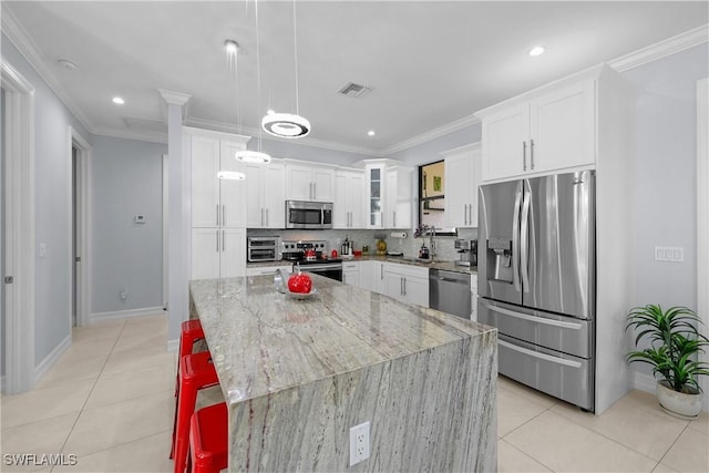 kitchen featuring ornamental molding, stainless steel appliances, and a sink