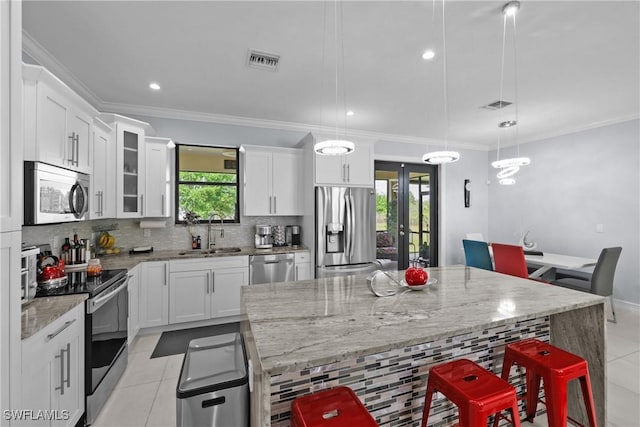 kitchen featuring light tile patterned floors, visible vents, a sink, decorative backsplash, and stainless steel appliances