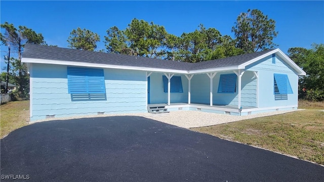 view of front of property with a porch, a front yard, and crawl space