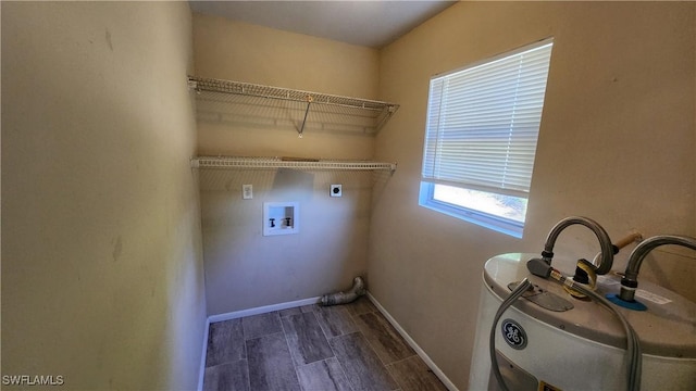 washroom featuring laundry area, baseboards, hookup for an electric dryer, and wood finish floors