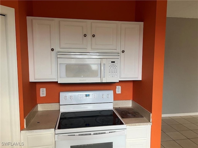 2609 4th St SW, Lehigh Acres, FL 33976 - kitchen featuring white appliances, white cabinets, and light countertops