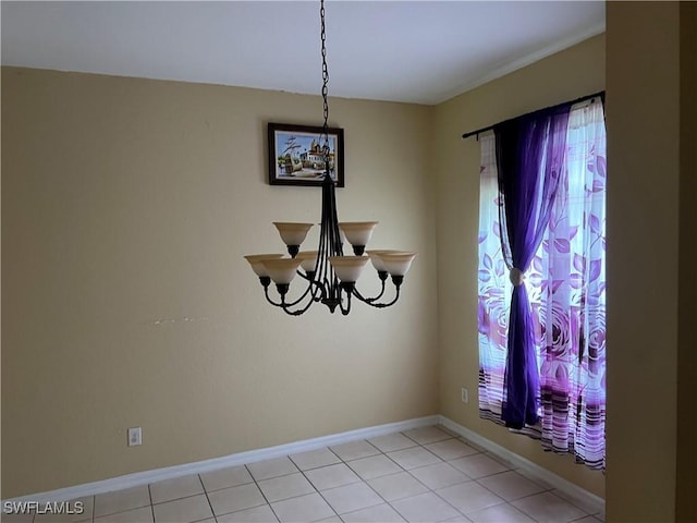 2609 4th St SW, Lehigh Acres, FL 33976 - unfurnished dining area with a chandelier and baseboards
