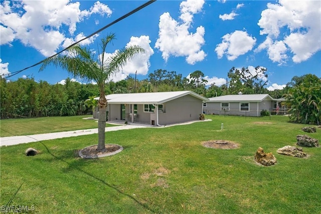 rear view of property featuring fence and a lawn