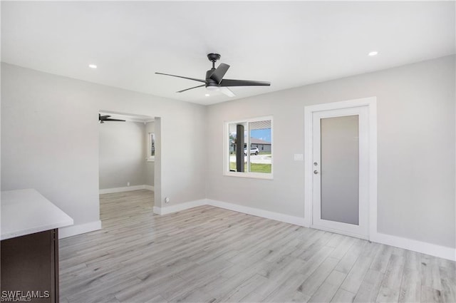 empty room featuring recessed lighting, baseboards, light wood-style floors, and ceiling fan