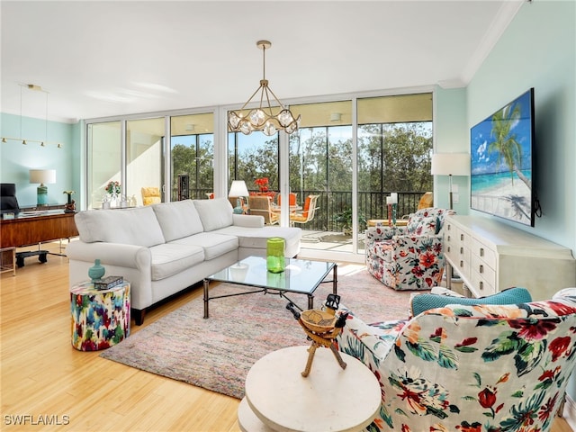 455 Cove Tower Dr Unit 303, Naples, FL 34110 - living room featuring a wall of windows, wood finished floors, ornamental molding, an office area, and a chandelier