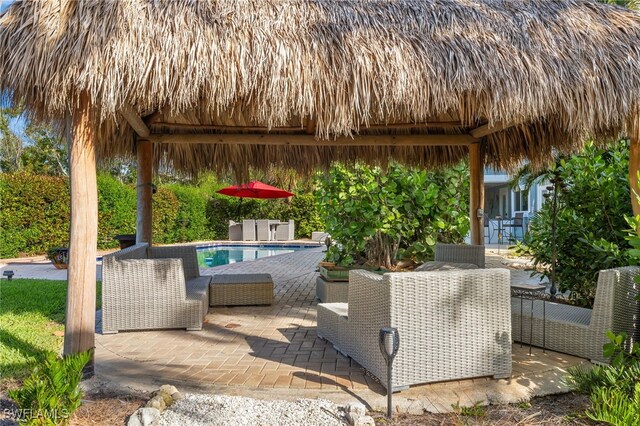 view of patio featuring an outdoor pool, outdoor dining area, and a gazebo