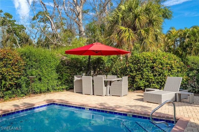 outdoor pool with a patio area