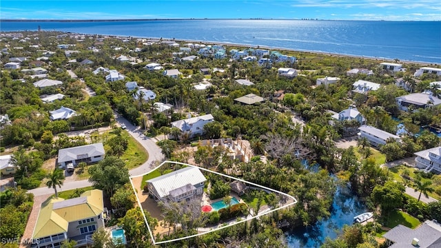 drone / aerial view featuring a residential view and a water view