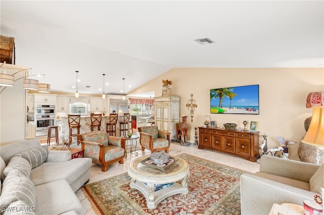 living room with vaulted ceiling and visible vents