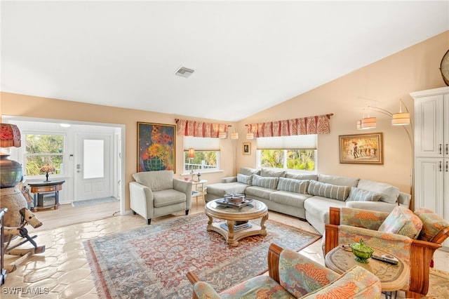 living room with vaulted ceiling and visible vents