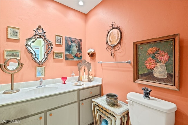 bathroom with toilet and vanity