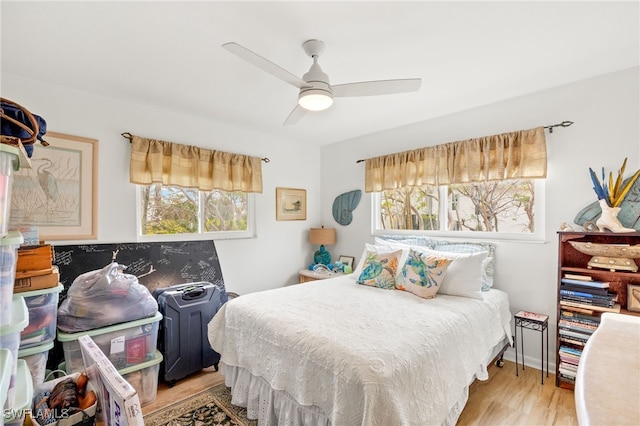 bedroom with ceiling fan and wood finished floors