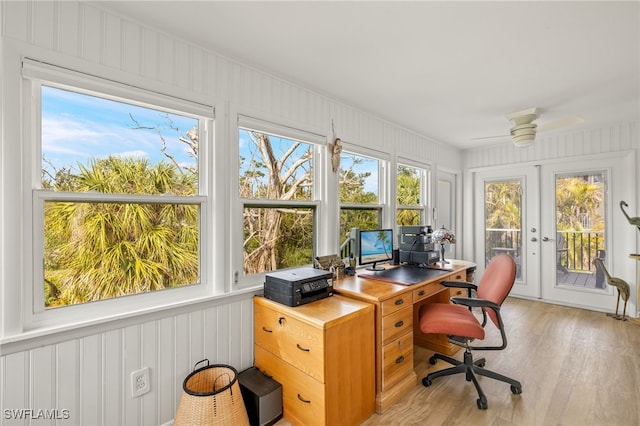 home office featuring light wood-style floors, french doors, and a ceiling fan