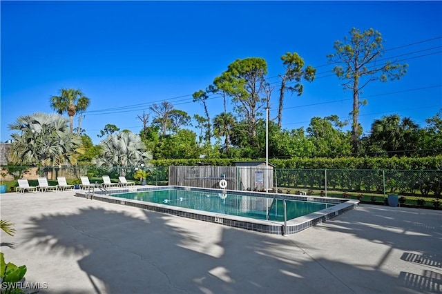 pool featuring a patio and fence