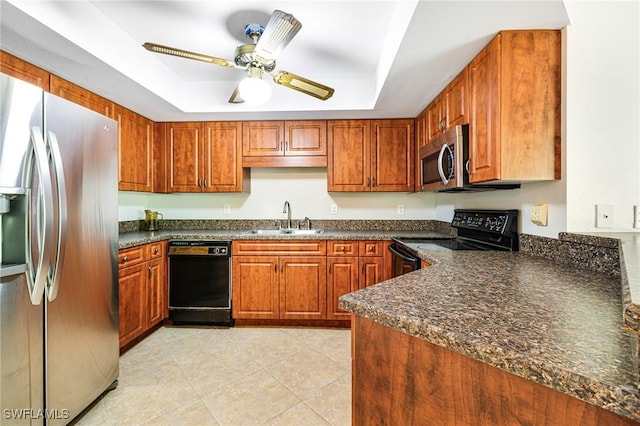 26955 Croise Dr, Bonita Springs, FL 34135 - kitchen featuring a sink, a ceiling fan, a tray ceiling, brown cabinetry, and black appliances