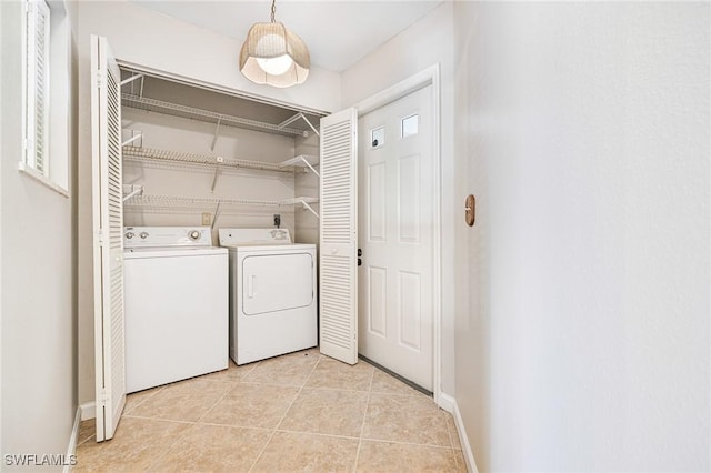 26955 Croise Dr, Bonita Springs, FL 34135 - clothes washing area with washer and clothes dryer, light tile patterned flooring, laundry area, and baseboards