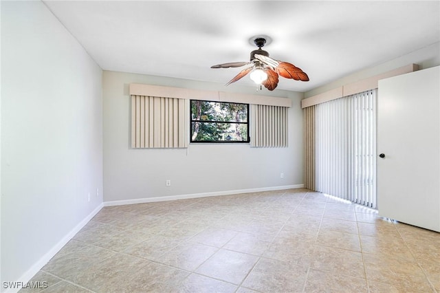 26955 Croise Dr, Bonita Springs, FL 34135 - empty room featuring ceiling fan, baseboards, and light tile patterned floors