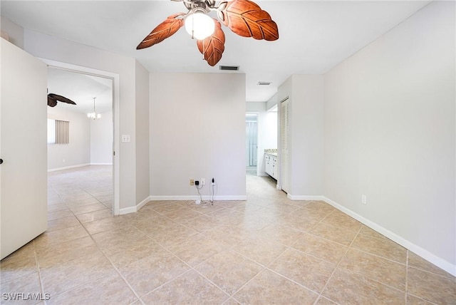 26955 Croise Dr, Bonita Springs, FL 34135 - empty room with light tile patterned floors, visible vents, ceiling fan with notable chandelier, and baseboards