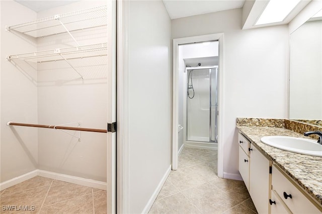 26955 Croise Dr, Bonita Springs, FL 34135 - full bath featuring a shower stall, vanity, a spacious closet, and baseboards