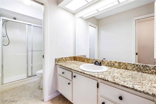 26955 Croise Dr, Bonita Springs, FL 34135 - full bathroom with a shower stall, tile patterned floors, vanity, and toilet