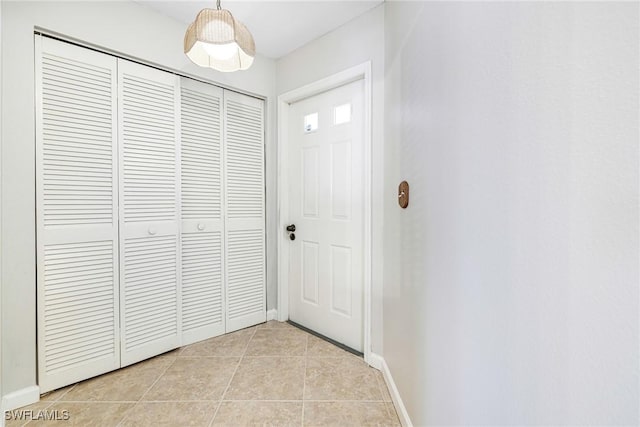 26955 Croise Dr, Bonita Springs, FL 34135 - doorway with light tile patterned floors and baseboards