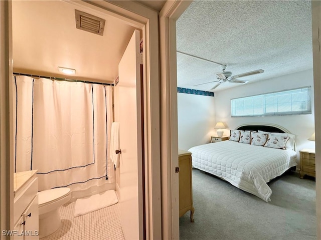 1900 Alamanda Dr Unit 208, Naples, FL 34102 - bedroom featuring carpet, a textured ceiling, and a ceiling fan