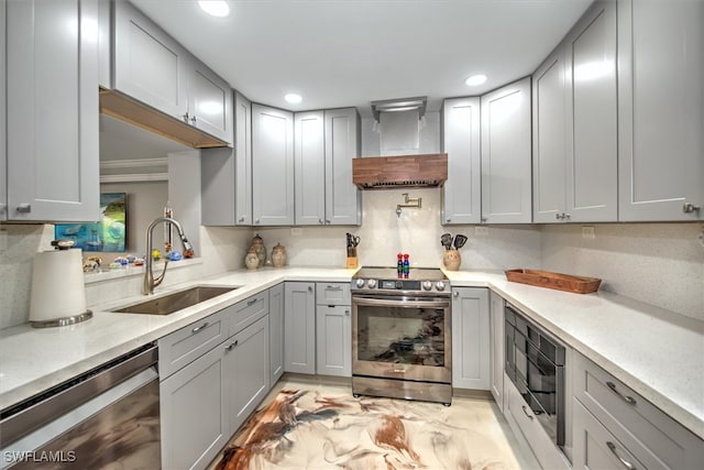 2215 Club House Rd, North Fort Myers, FL 33917 - kitchen featuring recessed lighting, gray cabinets, a sink, appliances with stainless steel finishes, and wall chimney range hood