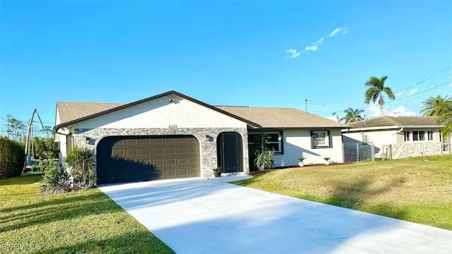 single story home with stucco siding, an attached garage, concrete driveway, and a front yard