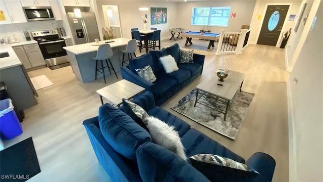 living area featuring light wood-type flooring and pool table