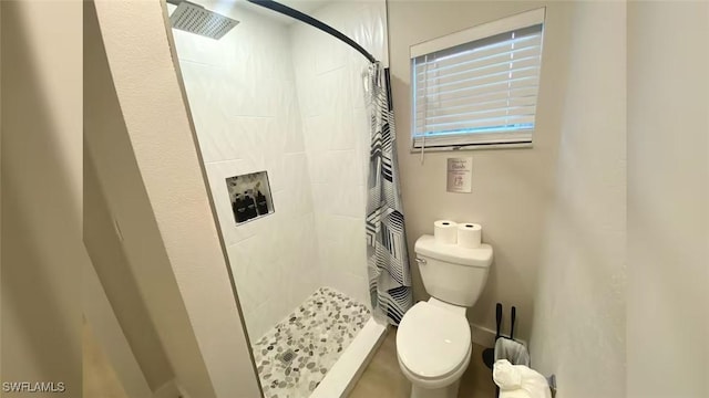 full bathroom featuring toilet and a shower stall