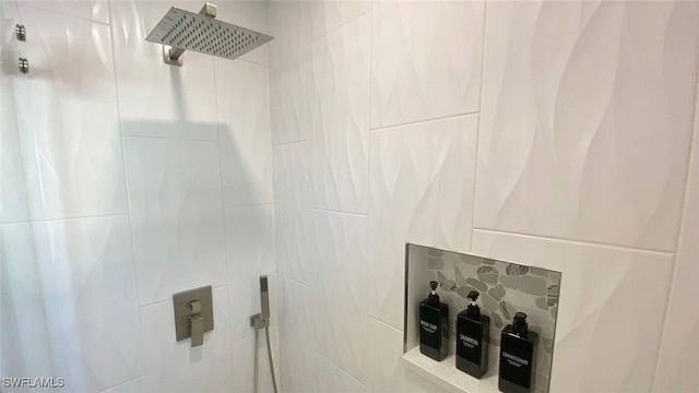 interior details with a tile shower