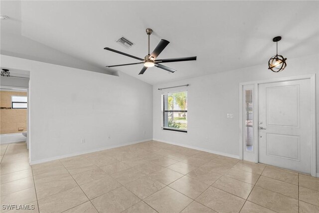 3734 SE 3rd Pl, Cape Coral, FL 33904 - interior space featuring visible vents, light tile patterned floors, baseboards, ceiling fan, and vaulted ceiling